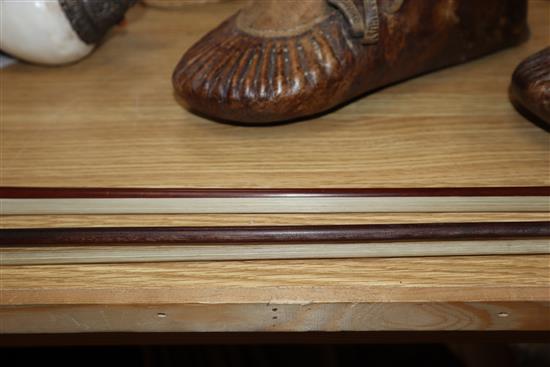 Two round stick violin bows with mother of pearl inlay, one with white metal mount